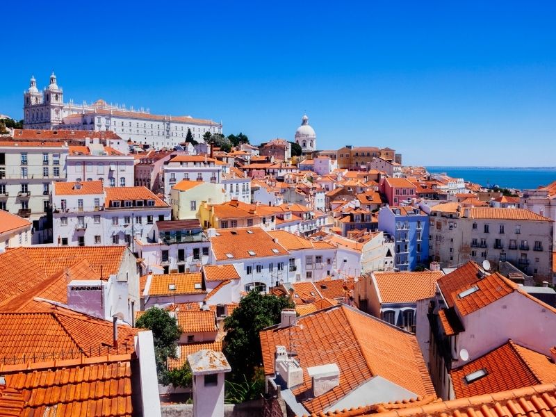 Colourful houses with coast in background