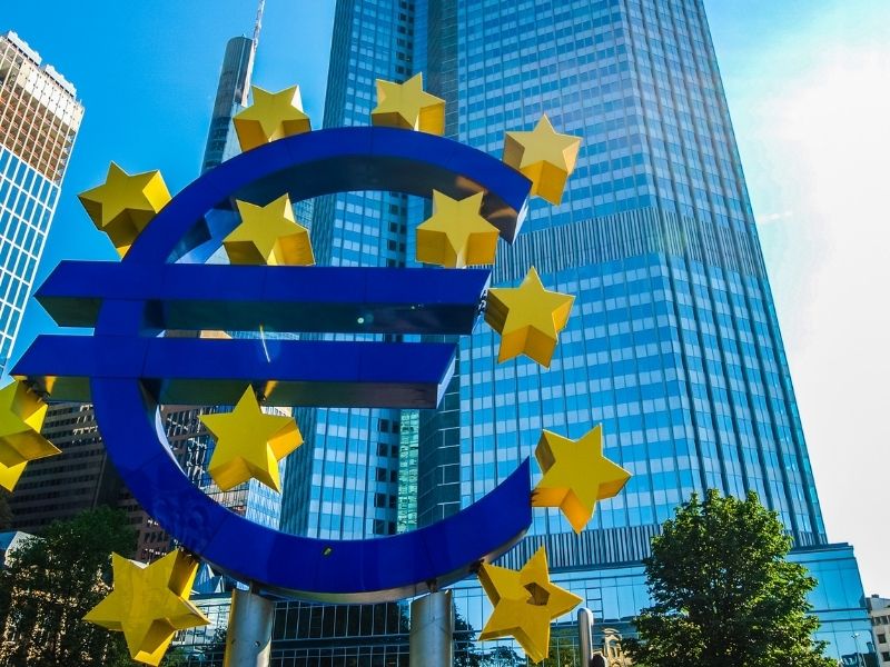 Euro statue in front of skyscraper