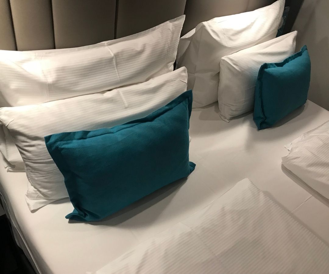 Neatly made bed in hotel room