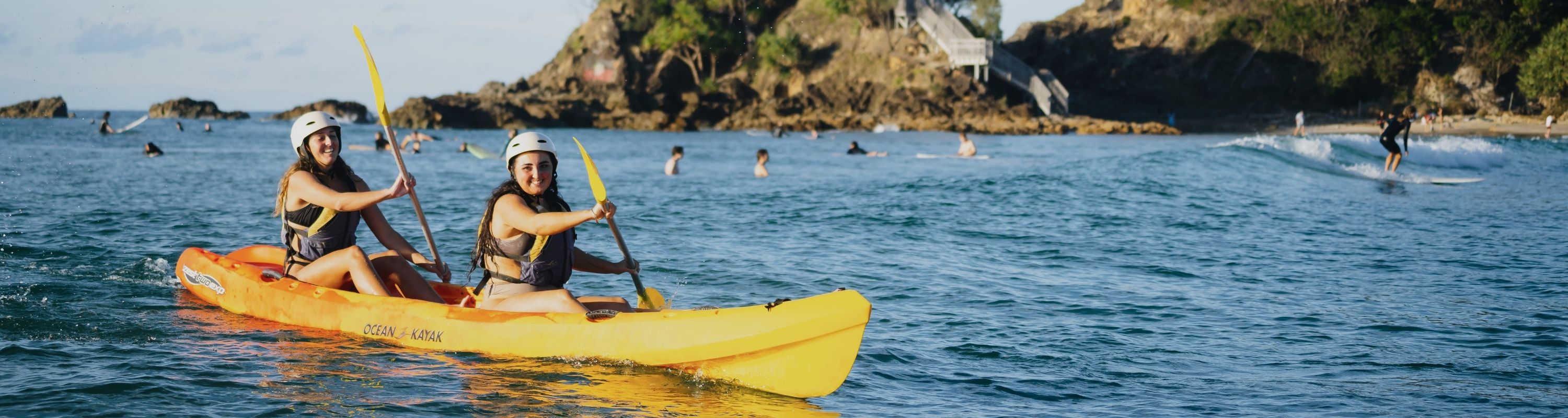 Two happy girls in sea kayaks