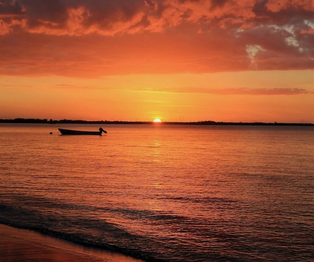 Sunset with boat in foreground