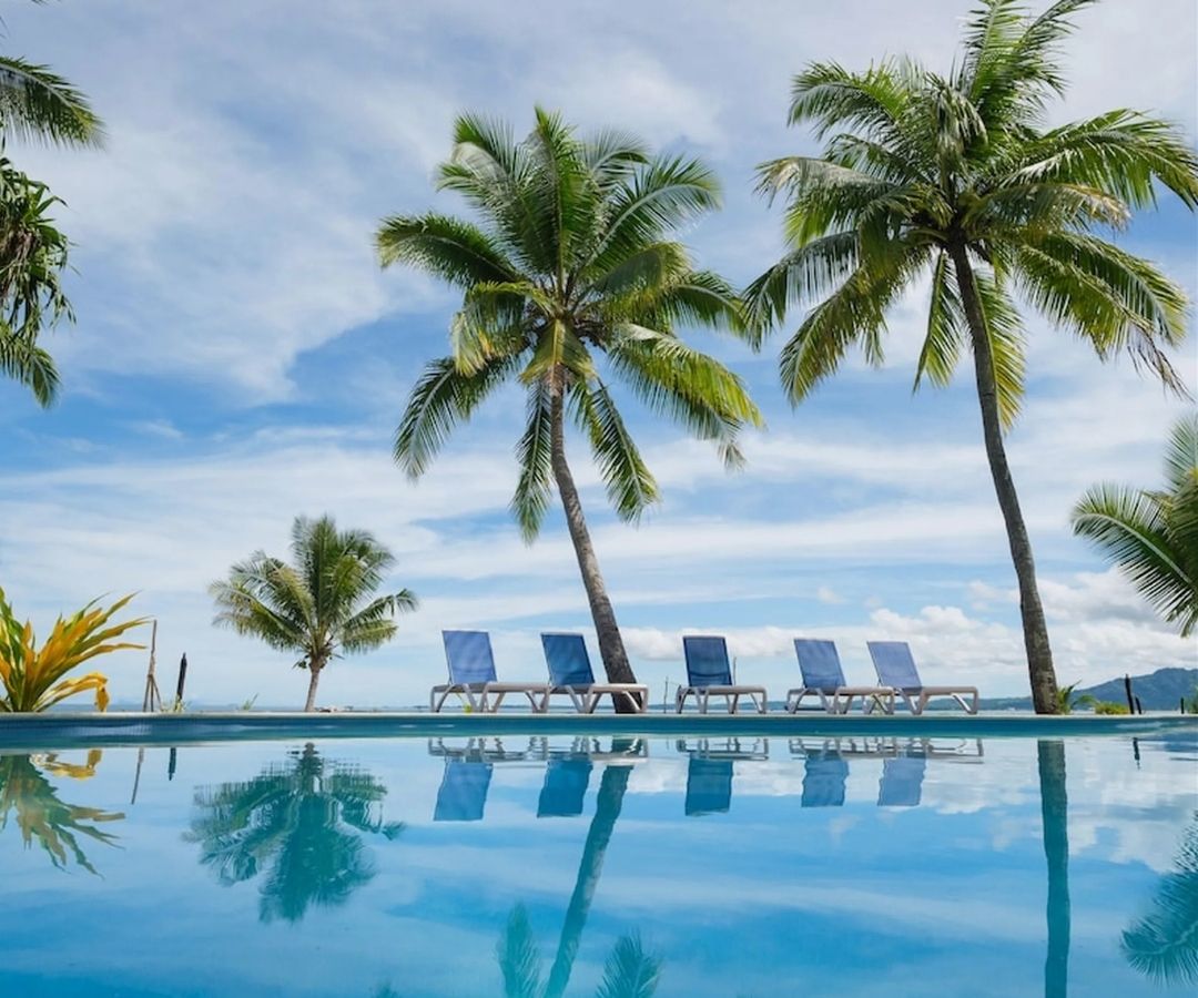 Hotel pool with palm trees