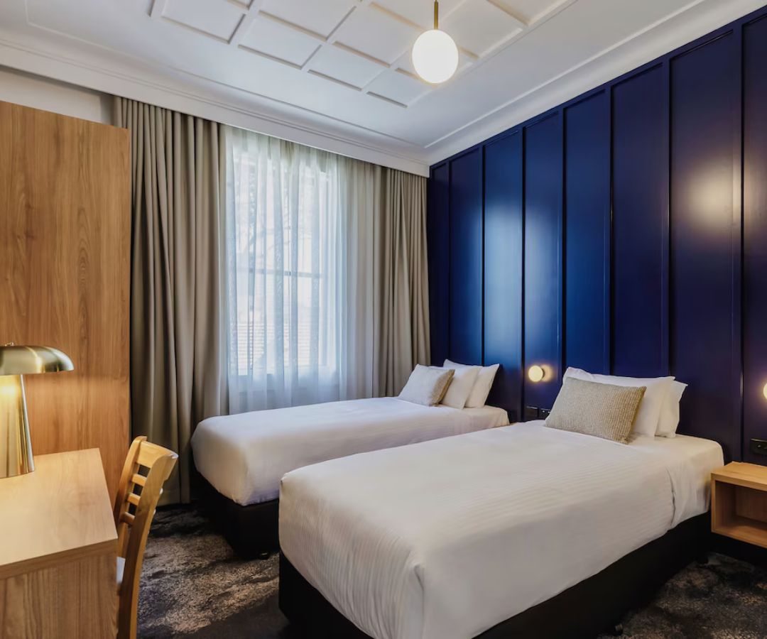 Elegant hotel room with blue feature wall
