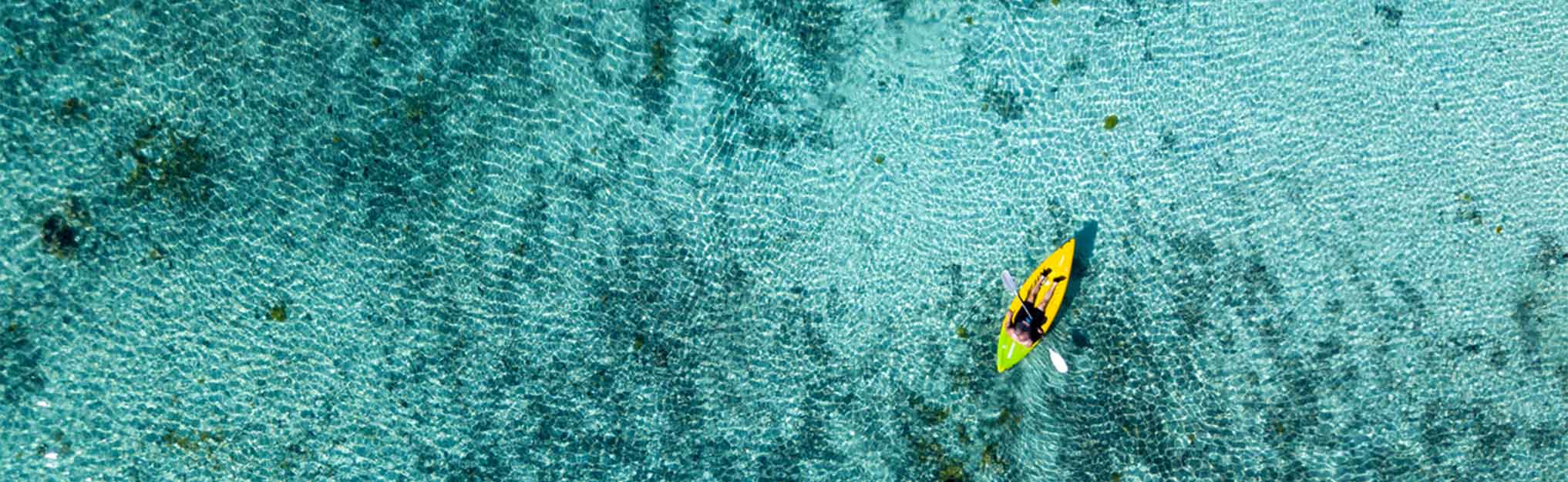 Canoe and kayaks in Polynesia Cook Island tropical paradise aerial view