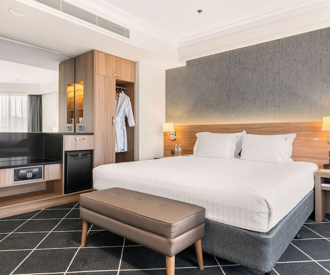 Modern hotel room with kitchenette and wardrobe