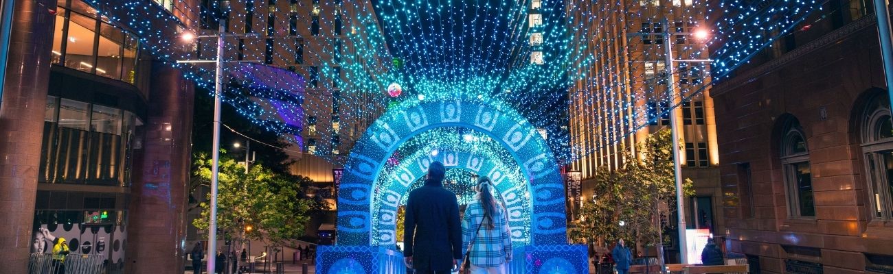 Lit up alley with couple walkin