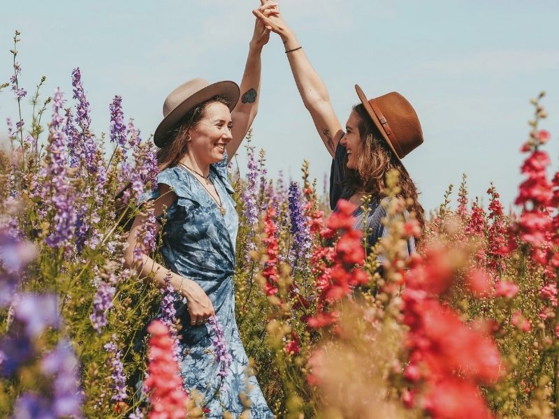 friends hanging out in flower field