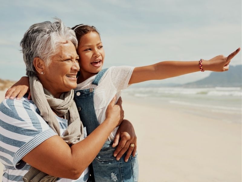grandmother and granddaughter on beach