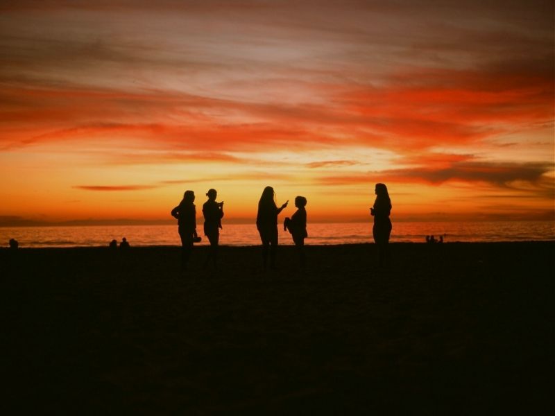 group at the beach at sunset
