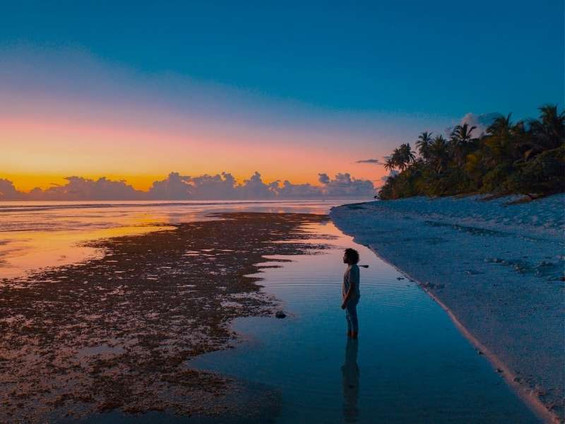 man on beach at sunset