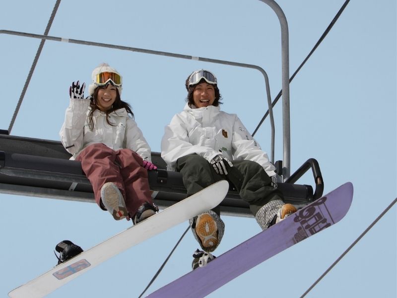 skiers on snow lift