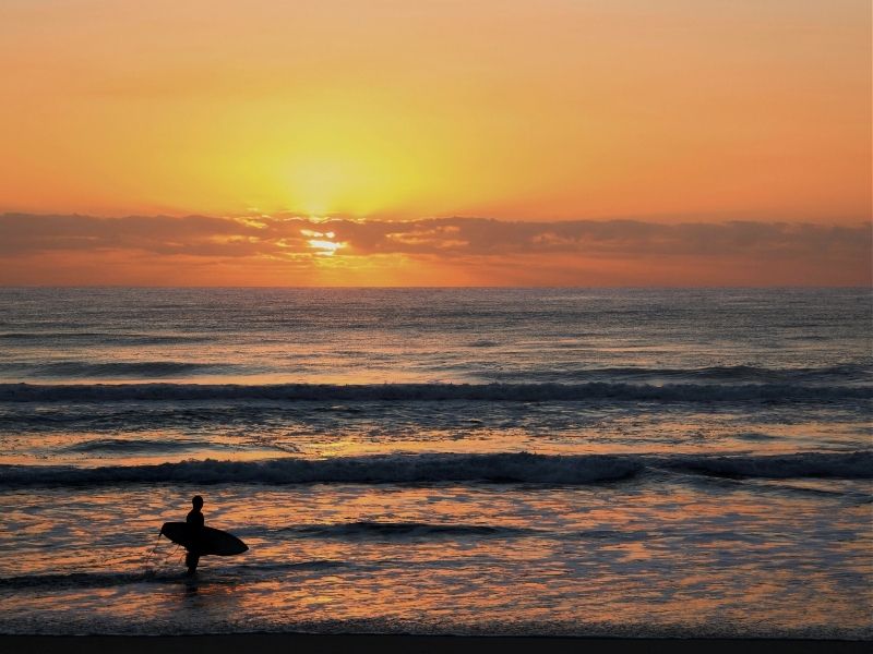 solo sufer at sunset