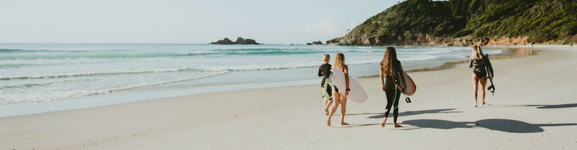 surfers on byron bay beach