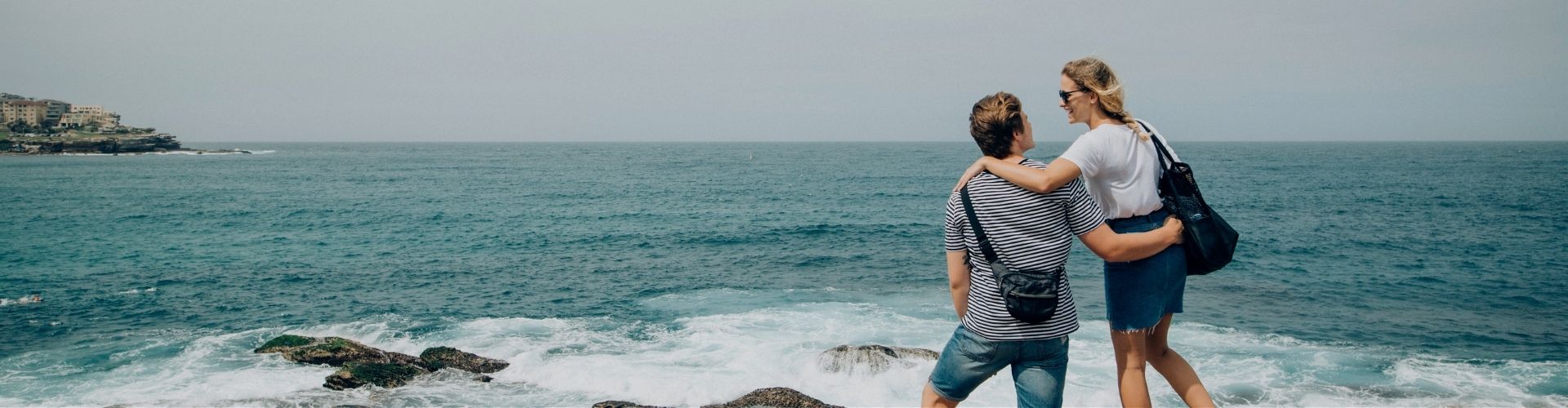 Couple hugging next to the ocean