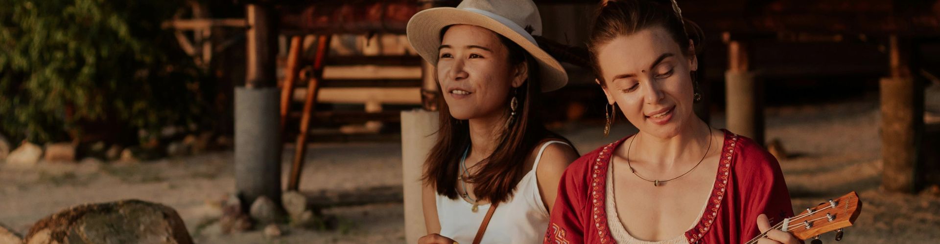 relaxing on beach while playing on ukelele